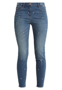 Smalle blauwe spijkerbroek met bloemborduring, versleten details, vijf-pocket ontwerp en onafgewerkte zoom.