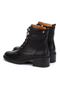 Black leather ankle boots with lace-up front, gold eyelets, brown interior lining, low block heels, and decorative stitching detail.