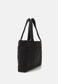 Black quilted tote bag with dual fabric straps, rectangular shape, and a textured surface. Features diamond pattern stitching throughout.