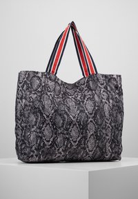Grote tote bag met een grijze slangenprint structuur, voorzien van rode en marineblauwe gestreepte handvatten. Zacht materiaal, afgeronde bovenkant en een ruim ontwerp.