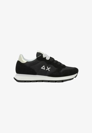 Sneaker basse bianco e nero con pannelli in suede e tessuto, lacci bianchi, suola bianca, e logo triangolo e X sul lato.