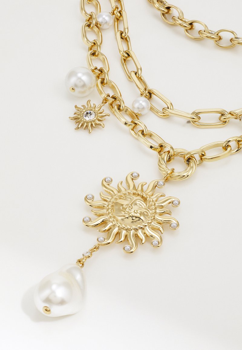 Collana Guess A Strati Con Ciondolo Tartaruga E Cristallo: Eleganza Dorata