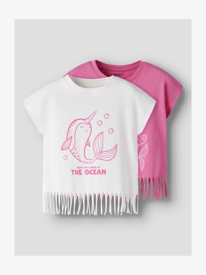 Two children's fringe T-shirts, one white with pink narwhal and "Ready for a swim in the ocean" text, one solid pink with white design.
