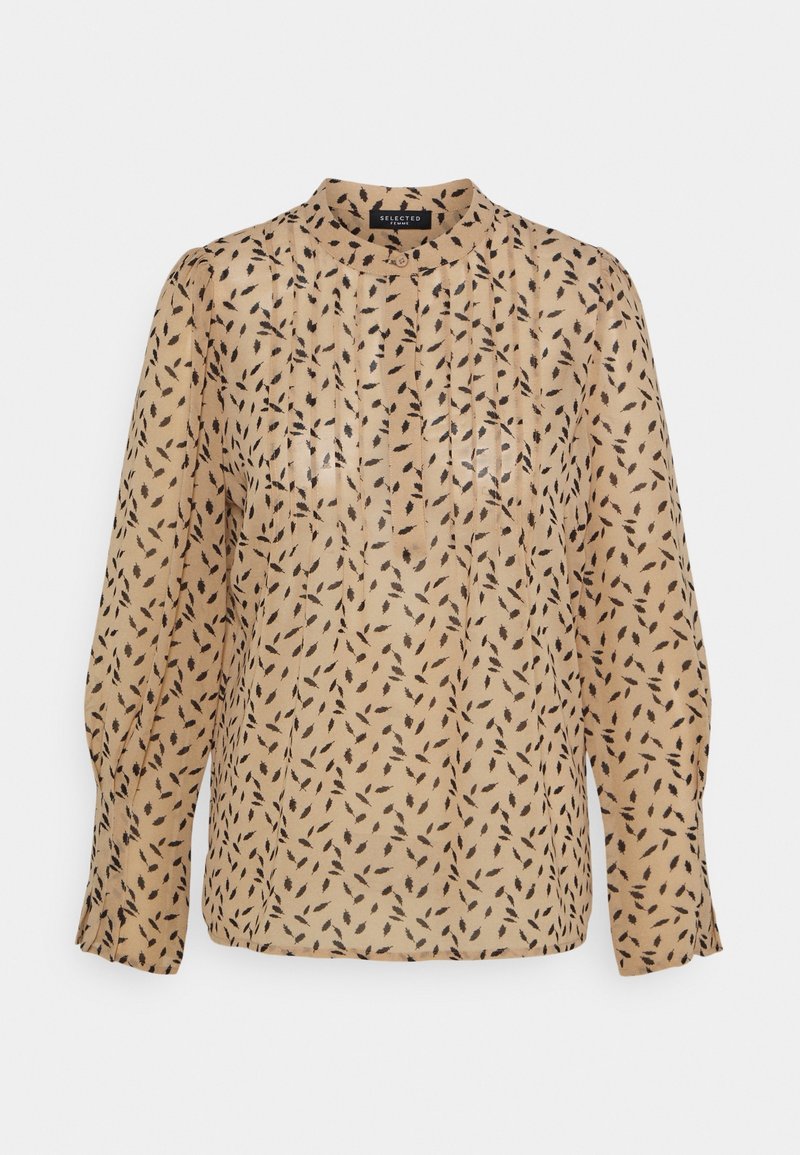 Sheer beige blouse with a high neckline, long sleeves, and black leaf-like pattern throughout. Features vertical pleats for texture.