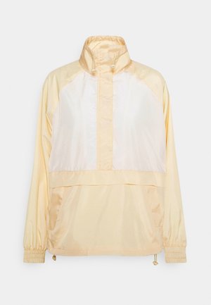 Jasnożółta kurtka oversize z wysokim kołnierzem, zamek błyskawiczny na pół, satynowe wykończenie, elastyczne mankiety i dwie boczne kieszenie.