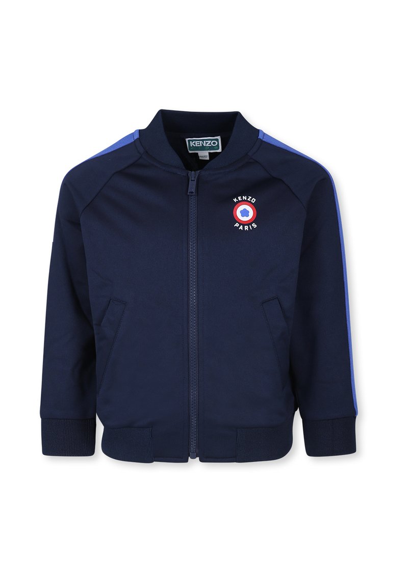 Veste zippée marine en tissu lisse, dotée d'un emblème rond avec le texte "KENZO PARIS", des poignets côtelés et des rayures bleues sur les épaules.
