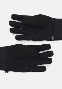 Gants noirs en matériau extensible, avec des accents de grip texturé noir sur les paumes. Comprend un détail de bande réglable au niveau du poignet.