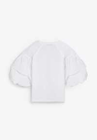 Top blanco con mangas abullonadas voluminosas y un escote redondo sencillo, mostrado desde la espalda sobre un fondo liso.