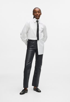 COATED STRAIGHT DENIM PANTS - Straight leg jeans - coated black denim