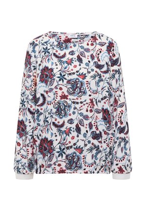 Blusa blanca de manga larga con estampados florales y foliares en azul, rojo y negro, escote redondo y puños fruncidos.