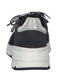 Black sneakers featuring a silver accent at the heel, textured fabric, white midsole, and a zipper detail for secure fastening.