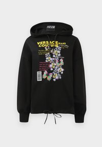 Sweatshirt preto com capuz, apresentando gráficos coloridos de flores e borboletas, texto impresso e cintura com cordão. O material é suave e texturizado.