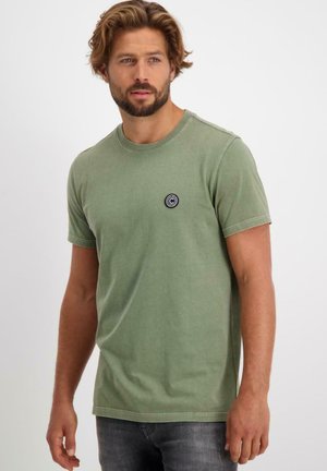 Groene t-shirt met korte mouwen, gemaakt van zachte katoen, met een ronde hals en een klein zwart cirkelvormig logo op de borst. Casual pasvorm.