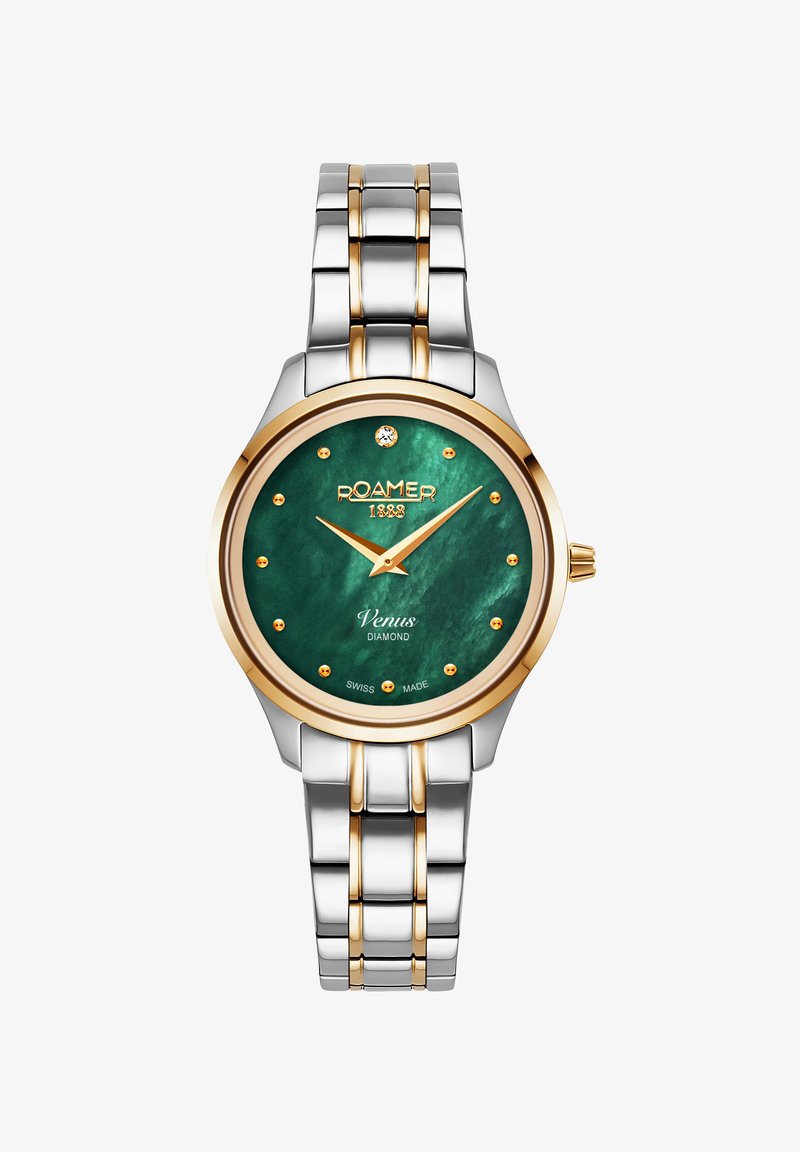 Roamer laikrodis su žaliu perlų galiuku, auksiniais akcentais ir deimantiniais žymekliais. Nerūdijančio plieno apyrankė su auksiniais saitais, apvalus sidabrinis korpusas.