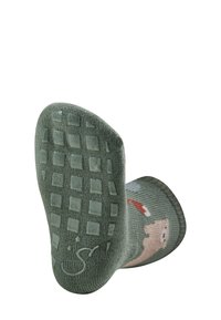 Green textured socks with grippy squares on the sole, featuring a cartoon character design and a smooth knit finish.