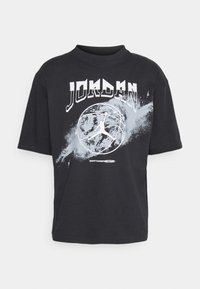 Black cotton t-shirt with a loose fit, featuring "JORDAN" text and a basketball graphic in white and light blue accents. Short sleeves.