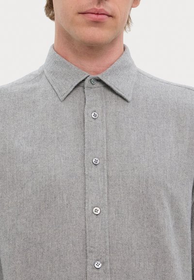 Gray button-up shirt made of textured fabric with a pointed collar, six buttons down the front, and subtle stitching details.