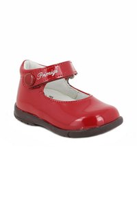 Scarpa Mary Jane in vernice rossa con strap in Velcro, suola in gomma nera e fodera interna bianca. Presenta la scritta "Primigi" in rilievo sulla fascia.