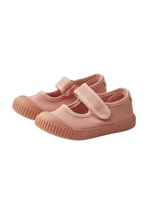 Light pink canvas shoes with a textured rubber sole, featuring a Velcro strap across the instep and a rounded toe design.