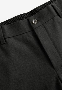 Black tailored trousers with a textured surface, featuring a button closure and an elastic waistband for comfort.