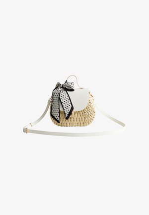 Petit sac bandoulière tissé avec rabat blanc, nœud à pois noirs et blancs, et fine sangle blanche réglable.