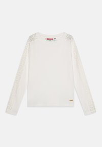 Chemise blanche à manches longues avec un corps côtelé et des détails en dentelle sur les manches. Dotée d'un col rond et d'un petit logo en métal près de l'ourlet.
