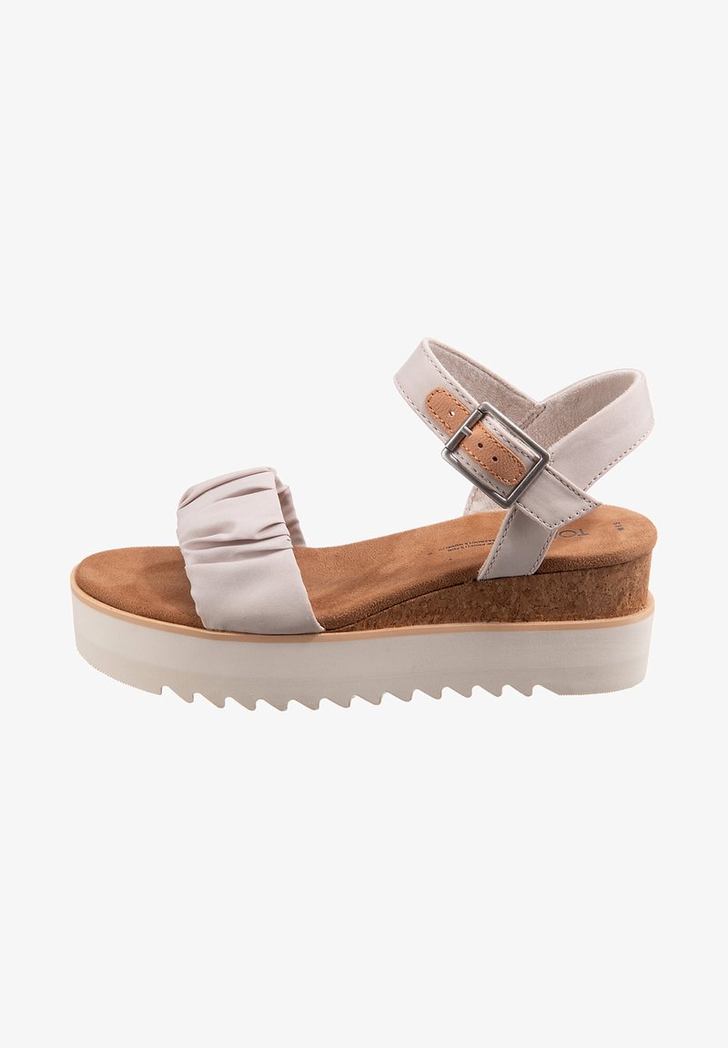 Light pink fabric sandal with a ruched strap, cork footbed, and a white, serrated platform sole. Adjustable ankle strap with metal buckle.