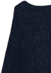 Black pleated dress with an intricate textured pattern. Features a wide neckline and long sleeves, showcasing a fluid and textured fabric.