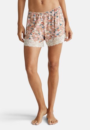 Bloemenprint shorts in lichtroze met een doorzichtige kantafwerking aan de zoom. Elastische tailleband voor comfort. Gemaakt van zachte stof.