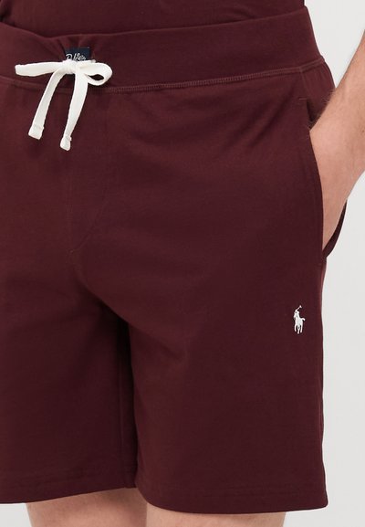 Bordo kratke hlače od mekanog materijala s pojasom na vezanje, s bočnim džepovima i bijelim izvezenim logom na lijevoj nozi.