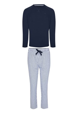 Navy long-sleeve top with crew neck and white pants with thin navy vertical stripes and a navy drawstring waistband.
