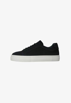 Zwarte suède sneaker met een witte rubberen zool, vetersluiting en een gladde afwerking op de bovenkant. Minimale accenten en een laag profiel.