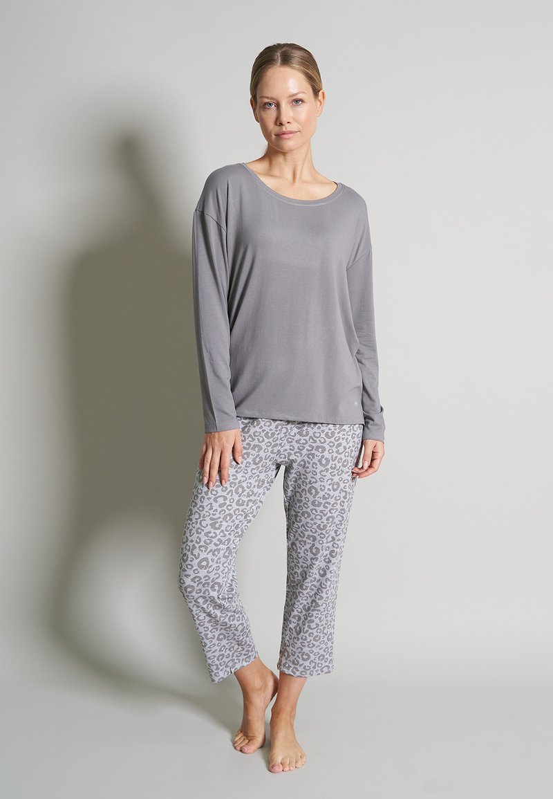 Gray long-sleeve top with a round neck paired with light gray leopard print cropped pants. Smooth fabric, relaxed fit, no visible hardware.
