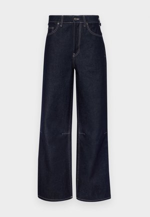 Mørkeblå denim bukser med bred benåpning, kontrasterende lys søm, knapp- og glidelås-lukking, samt frontlommer. Renslig design uten dekorasjoner.