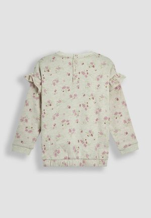 Svijetlosiva majica s kapuljačom s ružičastim cvjetnim uzorkom, naglascima na ramenima s volanima, zatvaranjem na tri gumba straga te rebrastim manžetama i pojasom.