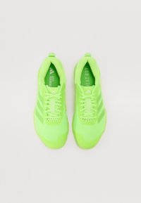 Bright green athletic shoes with a mesh upper, textured detailing, three stripes on the side, and a padded collar for comfort.