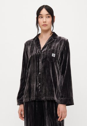 Velvet pajama top in dark gray with vertical stripes, button closure, collar, and left chest pocket featuring a small logo. Soft texture.