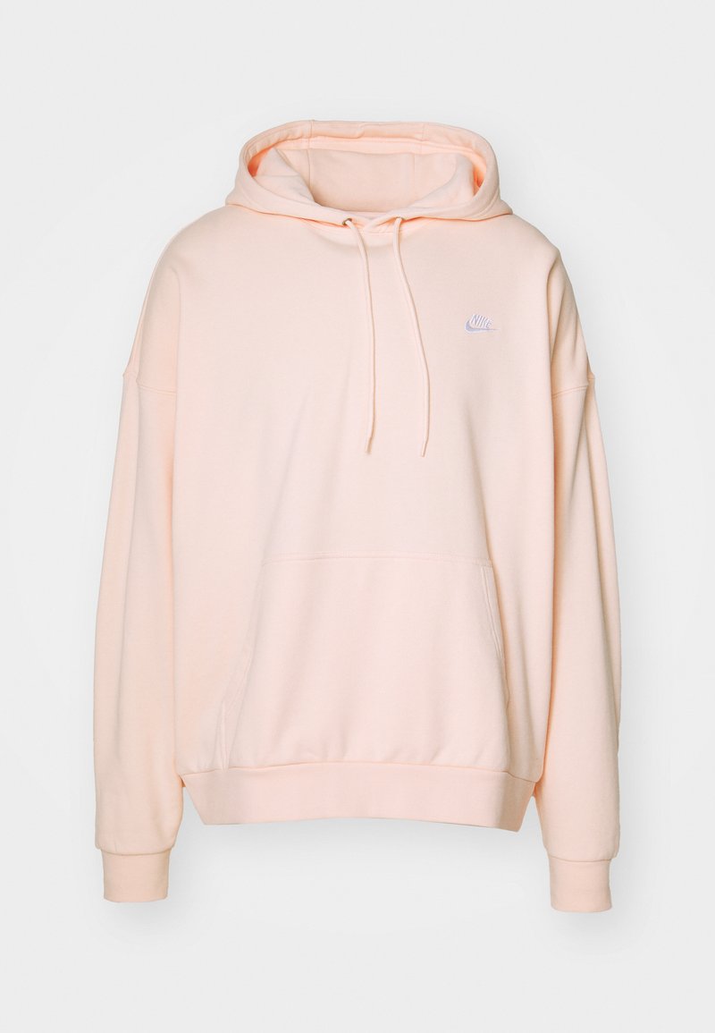 Bluza z kapturem uszyta z miękkiego, jasnego brzoskwiniowego materiału. Posiada kieszeń kangurzą, prążkowane mankiety oraz małe białe logo Nike na piersi.