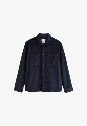 Marineblaues Corduroy-Hemdjackett mit Knopfverschluß, zwei Vordertaschen und einem spitzen Kragen, mit vertikaler Rippstruktur und langen Ärmeln.