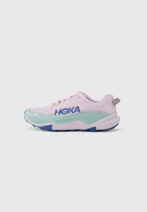 Light pink athletic shoe with green accents and blue sole. Features HOKA logo, mesh upper, textured detailing, and reinforced heel tab.