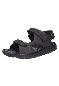 Sandalia negra con correas ajustables de Velcro, parte superior sintética texturizada y suela de goma a rayas. Cuenta con una plantilla acolchada para mayor comodidad.