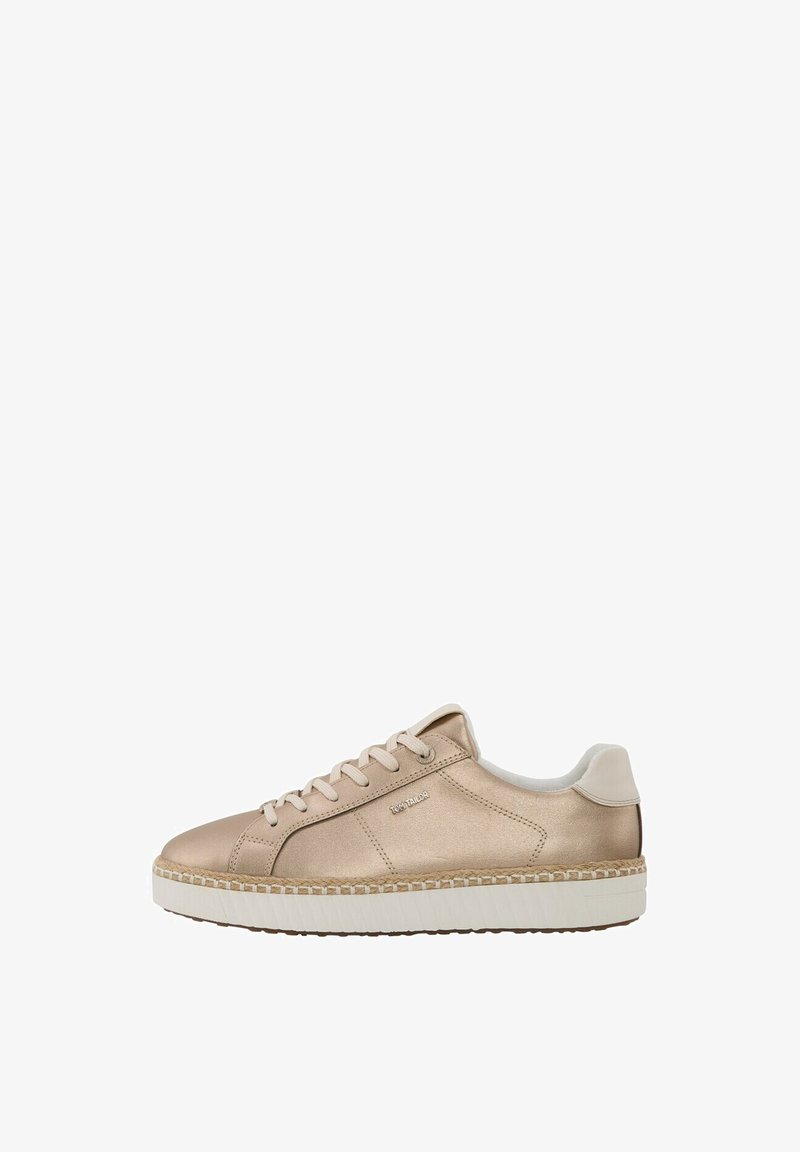 Beige sneaker, mille siled, läikiv viimistlus, ümmargune varvas, polsterdatud kaelus ja valge, tekstuurne põhjajoon. Brändi logo küljel.