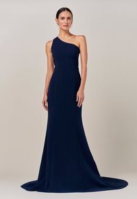 Temno modra obleka z enim ramenom, s prileganim zgornjim delom, razširjenim robom in subtilnim vlakom. Gladek tekstura s čistimi linijami in minimalnimi detajli.