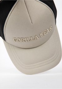 Beige and black cap with a structured design, featuring embroidered "GORILLA WEAR" text in a contrasting color on the front.