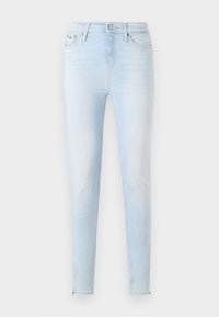 Svetlomodré úzke džínsy vyrobené z denimu. Majú vysoký pás, päť vreciek a detaily so zipsom pri členkoch. Celkové vyblednuté pranie.