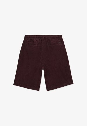Shorts en velours côtelé marron foncé pour homme, avec taille élastique et deux poches passepoilées à l'arrière, dont une avec une petite étiquette de la marque.