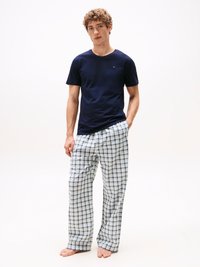 Navy blue cotton t-shirt paired with plaid pajama pants featuring white, blue, and green colors, loose fit, and an elastic waistband.