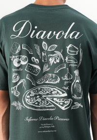 Back of dark green shirt with white illustrations of pizza ingredients, a pizza, and the text "Diavola" and "Inferno Diavola Pizzeria."