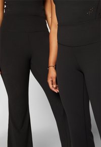 Athleta ELATION FLARE PANT - Leggings - black