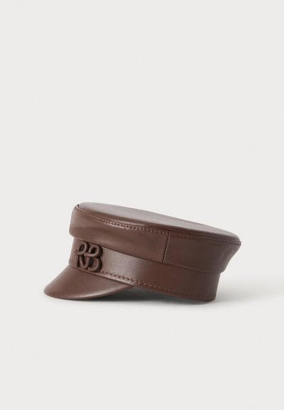 Casquette plate en cuir marron avec une visière courte et un logo décoratif entrelacé sur la bande avant, présentée sur fond blanc.